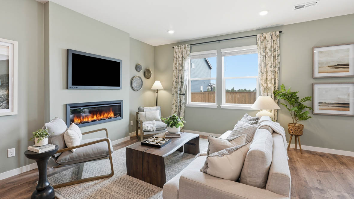 Stevens Ranch great room with couch and coffee table and two chairs with painted accent wall and fireplace
