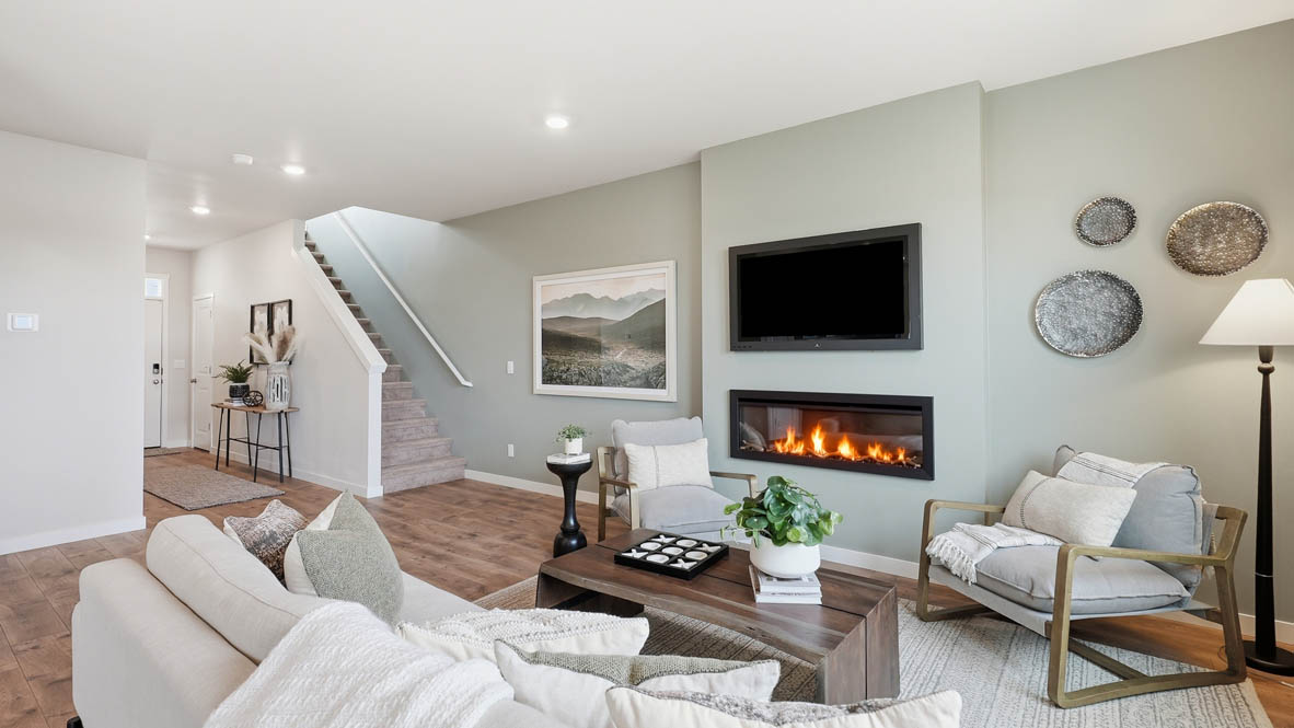Stevens Ranch great room with couch and coffee table and two chairs with painted accent wall and fireplace