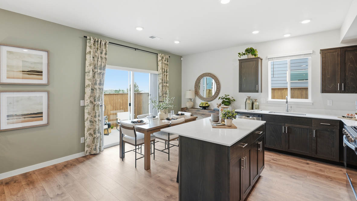 Stevens Ranch kitchen with stained shaker style cabinets, white quartz countertops, and stainless steel appliances