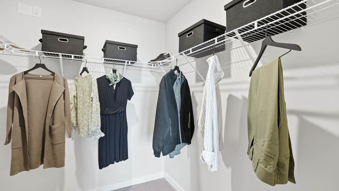 Stevens Ranch primary bedroom walk in closet with white wire shelving
