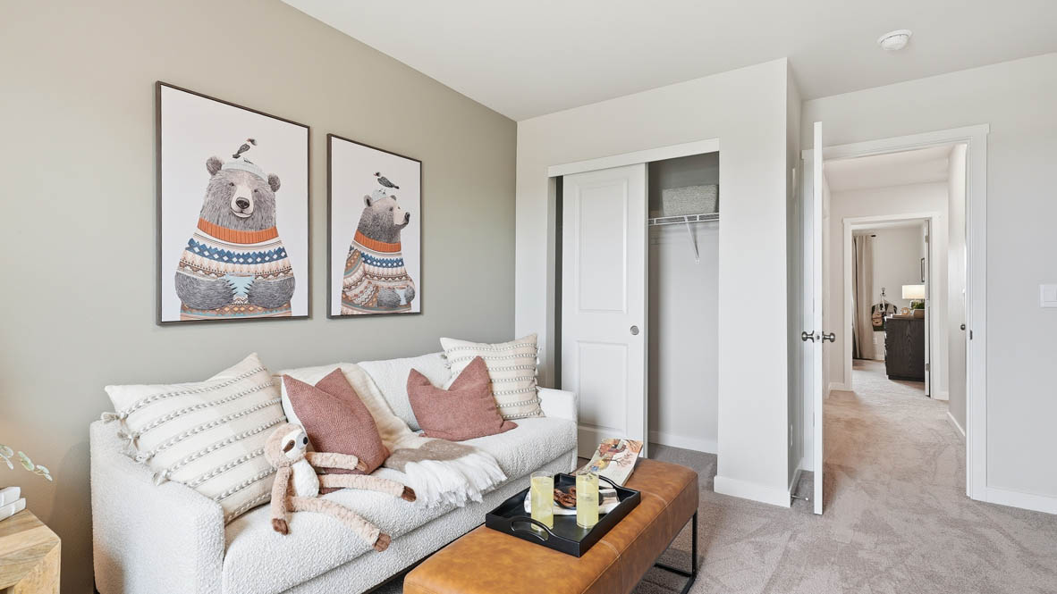 Stevens Ranch bedroom set up as den with couch and ottoman