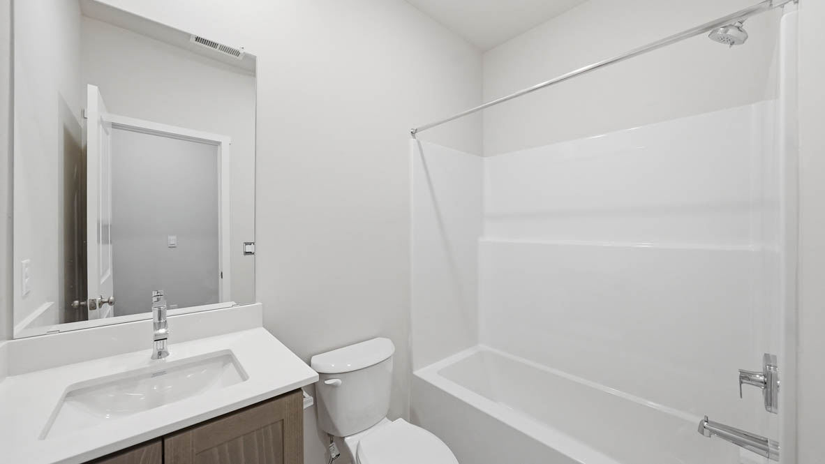 Stevens Ranch secondary bathroom with countertops, bathtub, toilet