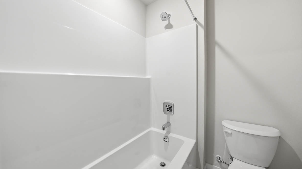 Stevens Ranch secondary bathroom with countertops, bathtub, toilet