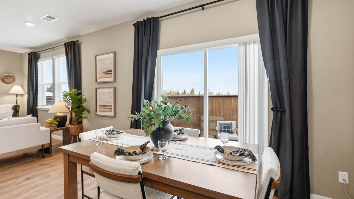 Stevens Ranch dining room with wood table, accent wall, table, decorative plant