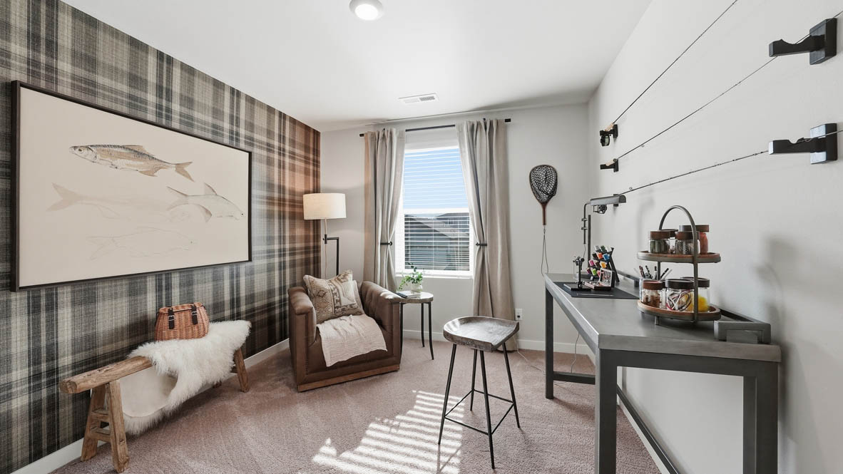 Stevens Ranch bedroom mock office with a desk, hung up shelves, a couch, chair, and a painting