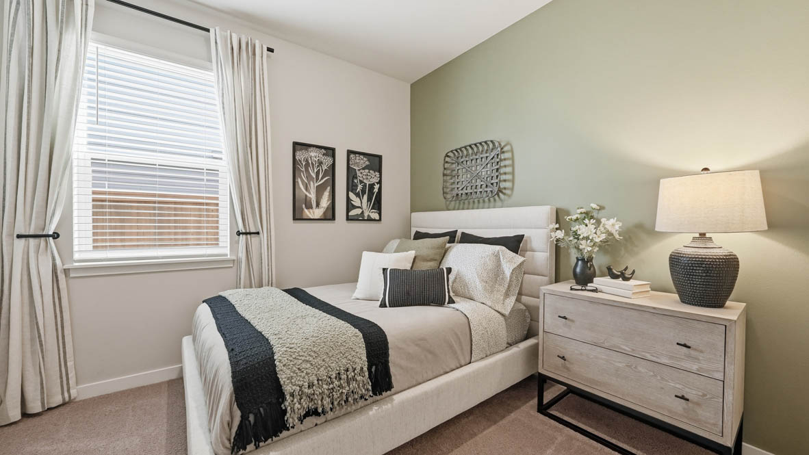 Stevens Ranch bedroom with a nightstand, dresser, light green drapes, paintings, carpet flooring and window
