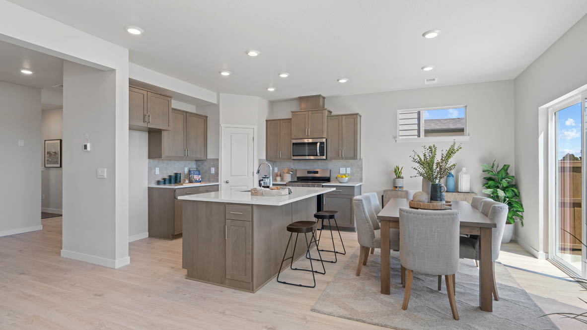 Stevens Ranch kitchen with laminate flooring, island with a sink, quartz countertops, stainless steel appliances, slide in glass door