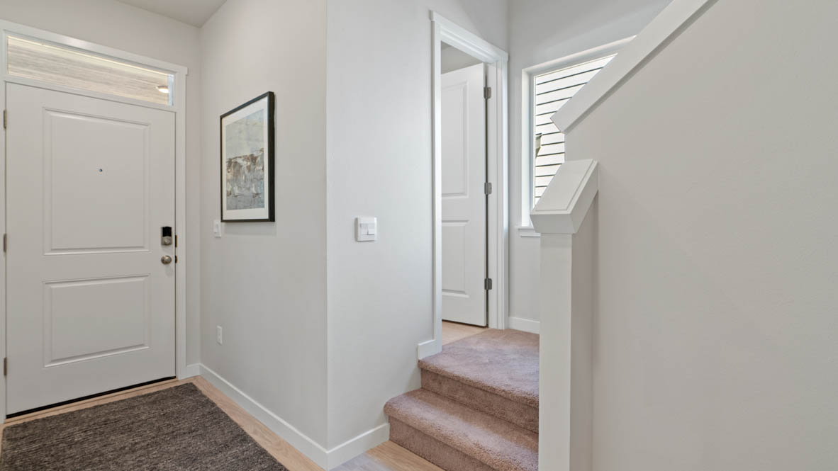 Stevens Ranch Entry with laminate flooring, window, staircase