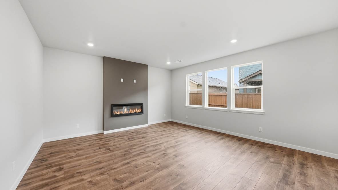 Stevens Ranch Great room with white walls, windows