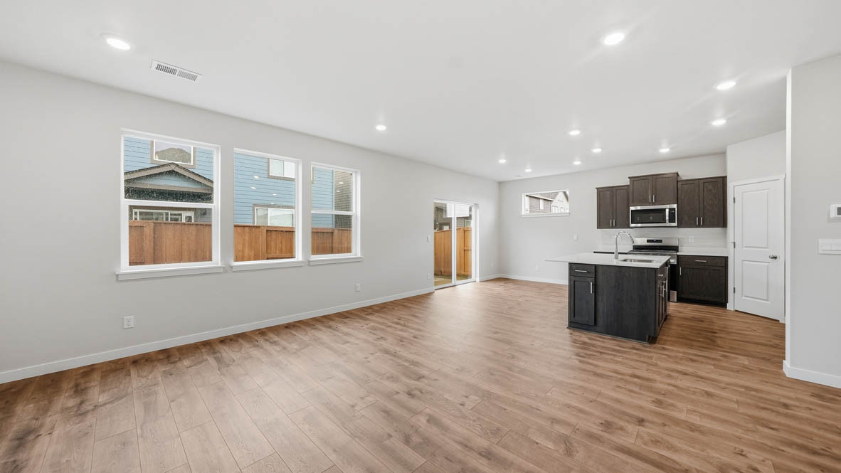 Stevens Ranch Great room with white walls, windows