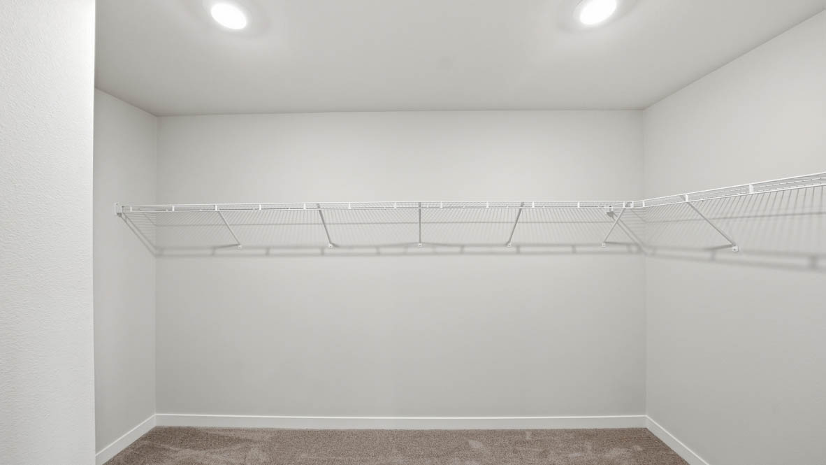 Stevens Ranch walk in closet with white wire shelving