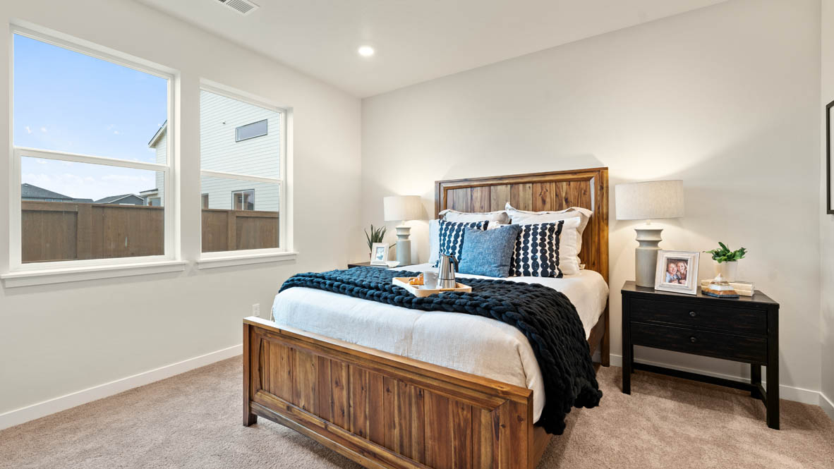 Stevens Ranch Primary Bedroom with carpet, bed, nightstand, mirror, dresser, and window