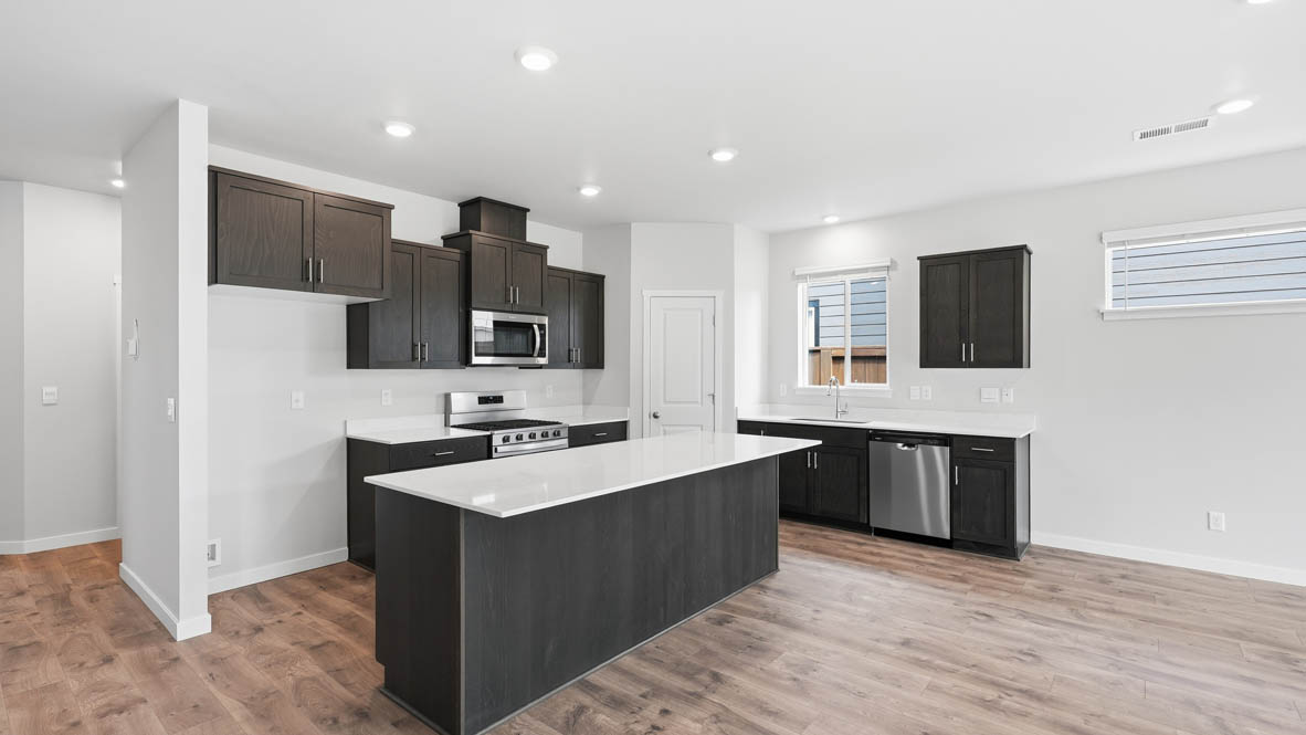 Stevens Ranch kitchen with brown stained cabinets and stainless steel appliances