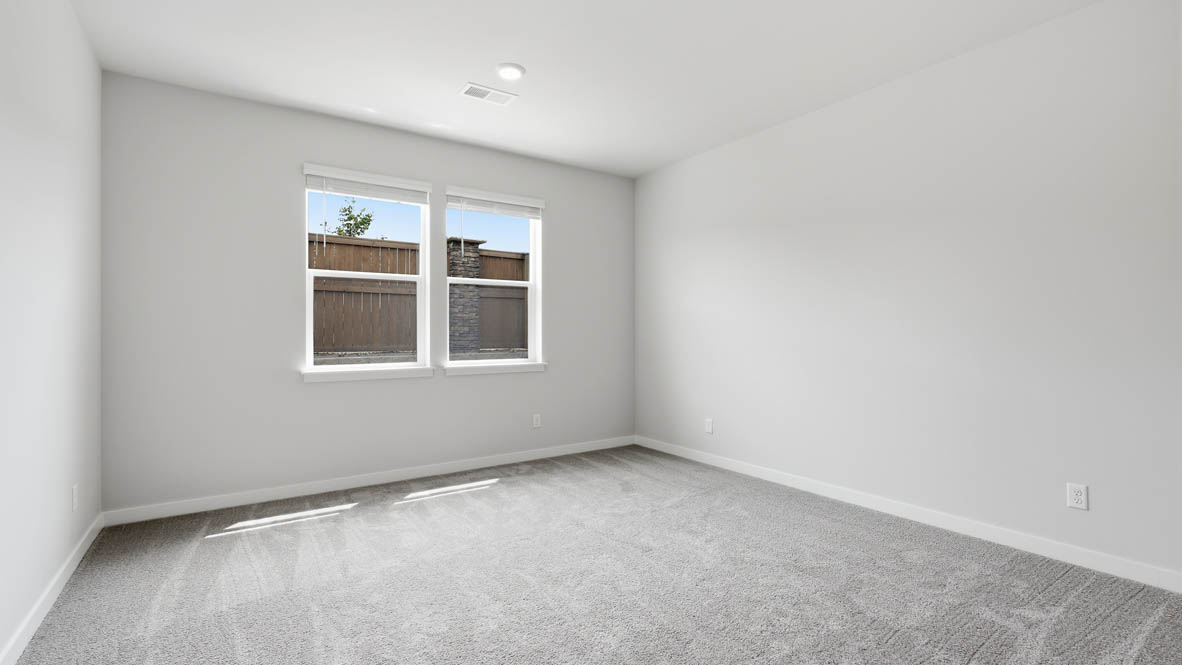 Stevens Ranch primary bedroom with carpet and white walls
