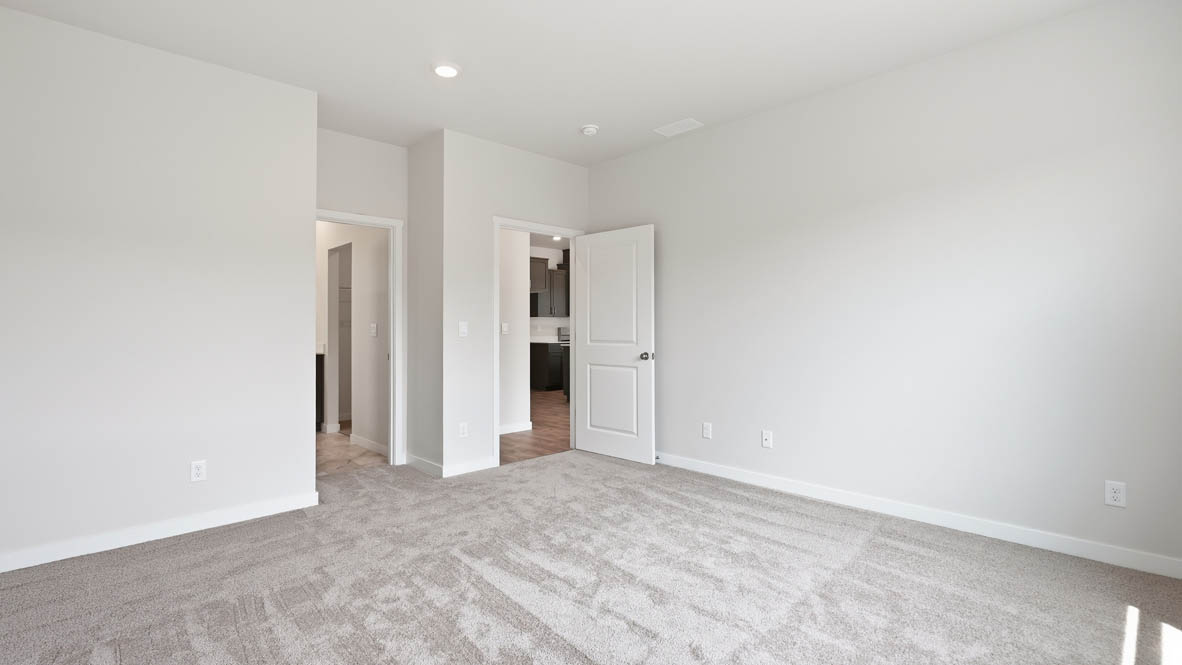 Stevens Ranch primary bedroom with carpet and white walls