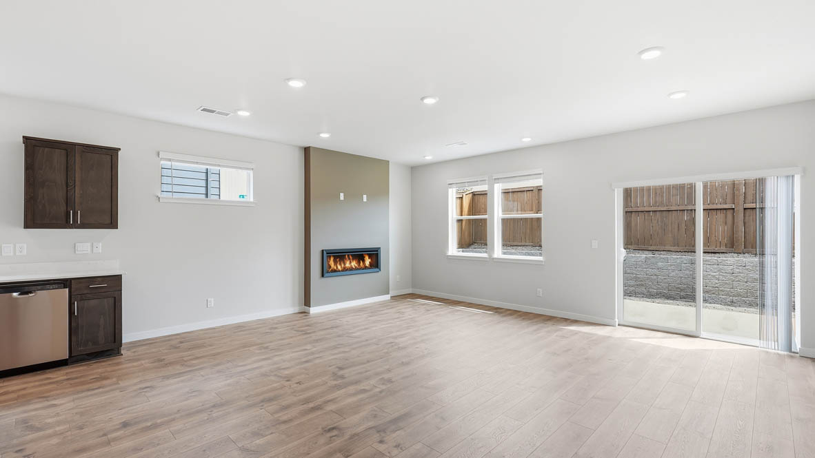 Stevens Ranch great room with laminate flooring, window and fireplace