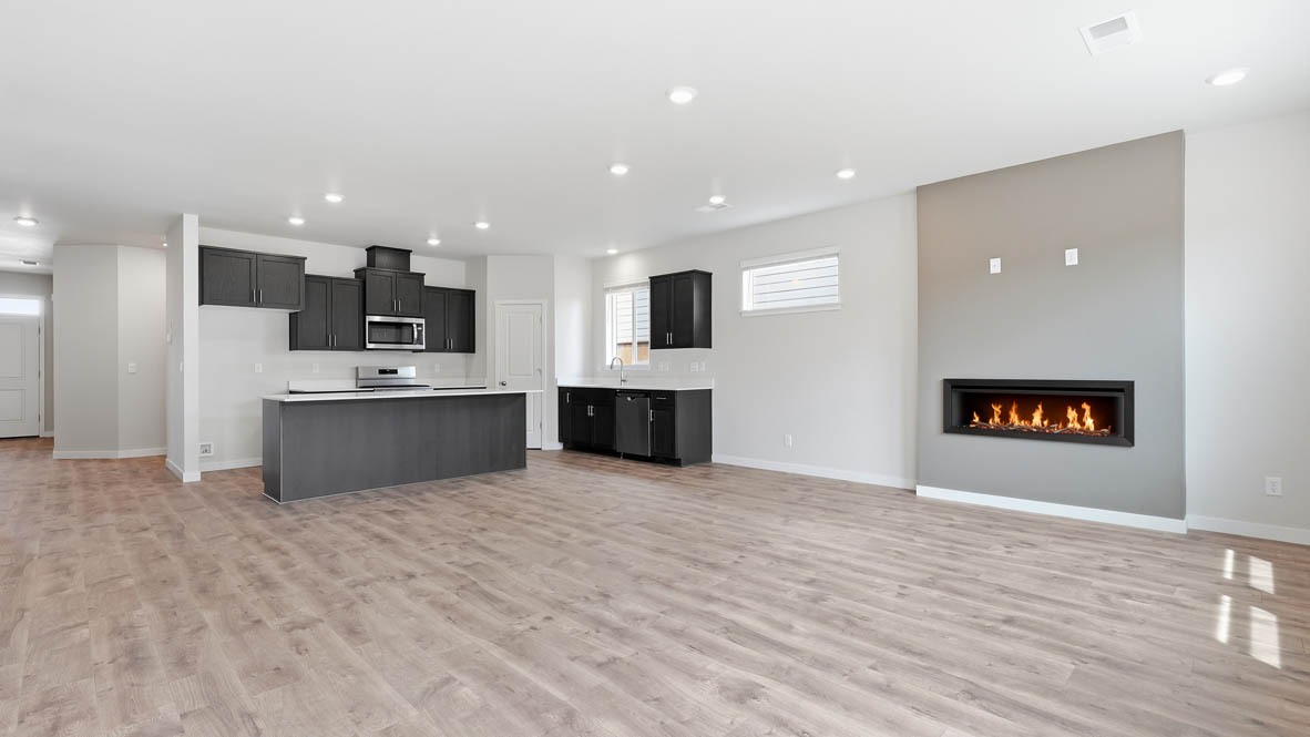 Stevens Ranch kitchen with dark stained cabinets and great room with fireplace