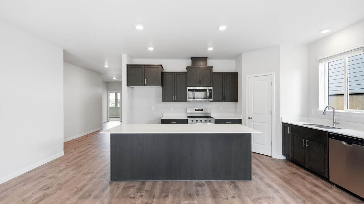 Stevens Ranch kitchen with dark stained cabinets and stainless steel appliances