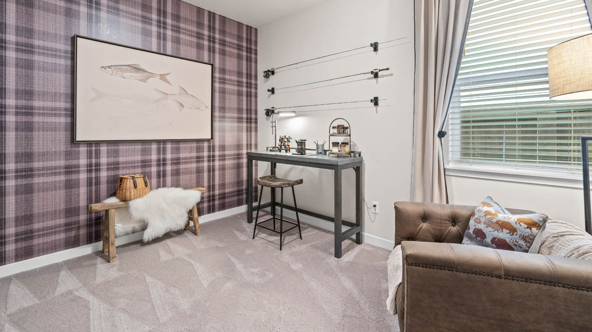 Stevens Ranch bedroom with carpet, brown couch, desk with a light, painting, plaid accent wall