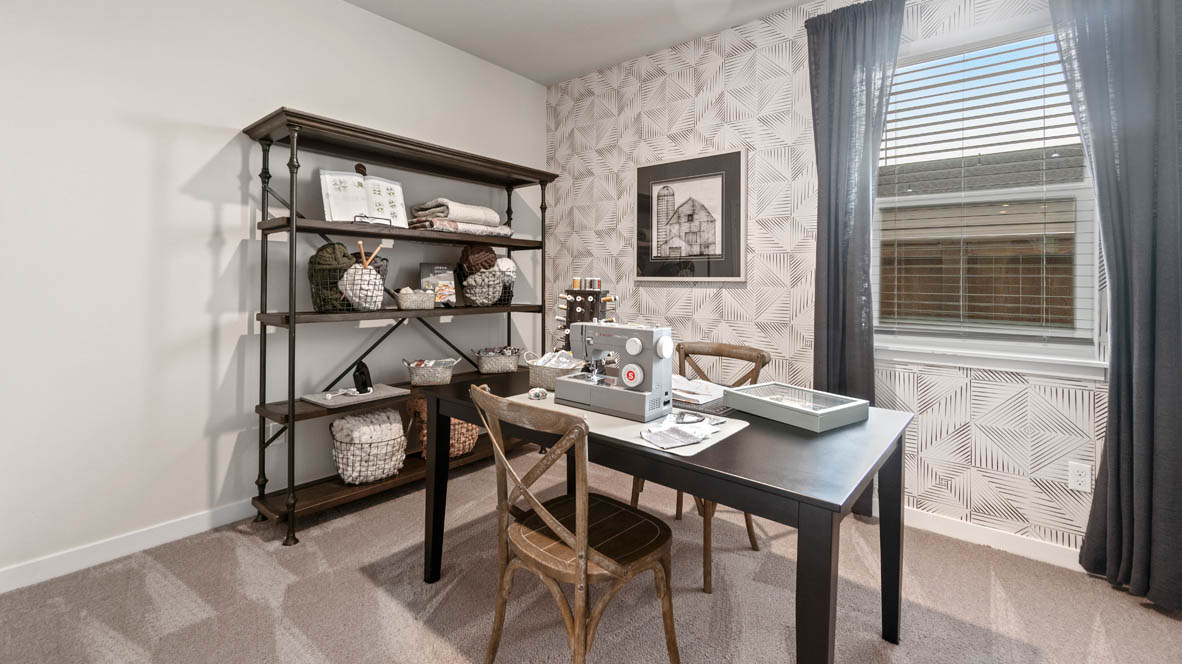 Stevens Ranch bedroom with carpet, shelving with decor, a desk with two chairs, and windows with blinds