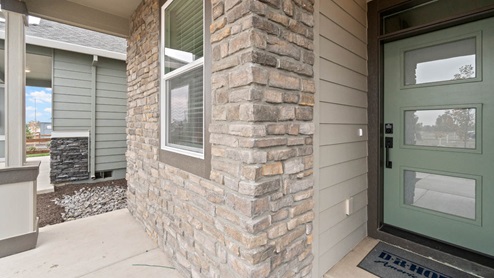 Stevens Ranch Entry with stone and green three window panel door