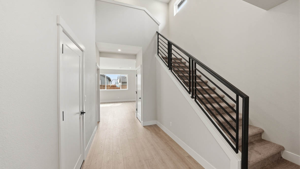 Stevens Ranch entry with laminate flooring and carpet stairs