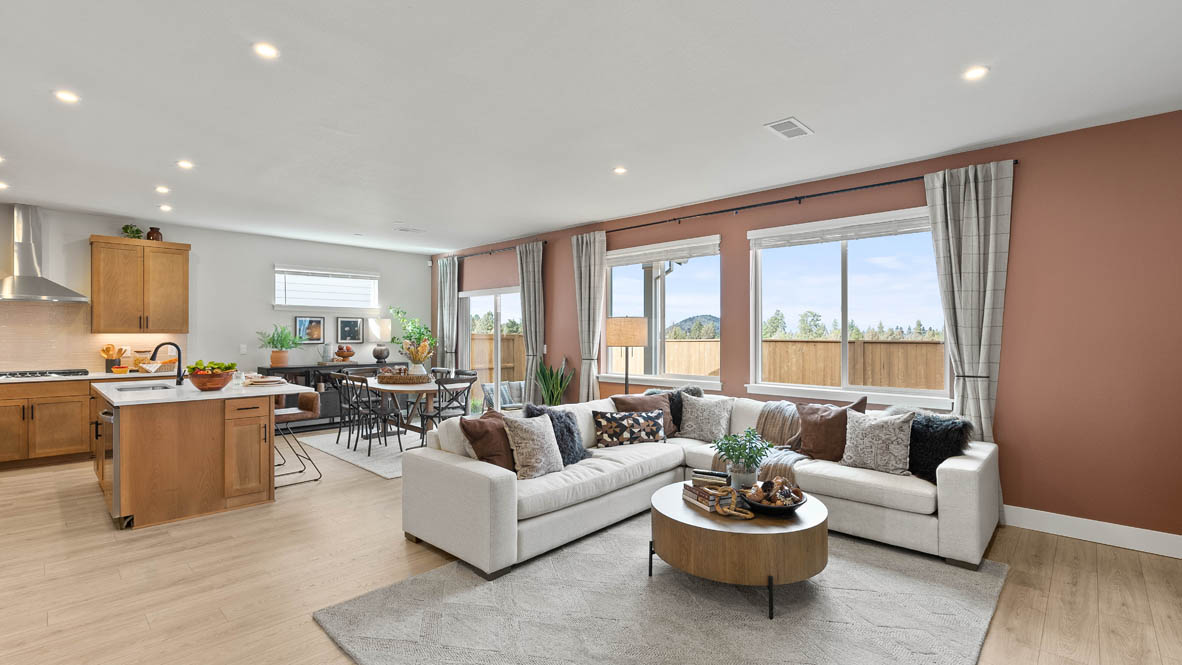 Stevens Ranch Diamond 3816 with hardwood flooring, fireplace, orange accent wall, white couches, coffee table,  two windows on the wall