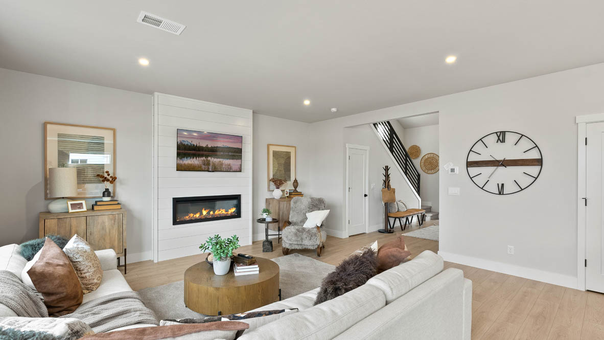 Stevens Ranch Diamond 3816 with hardwood flooring, fireplace, white accent wall, white couches, coffee table,