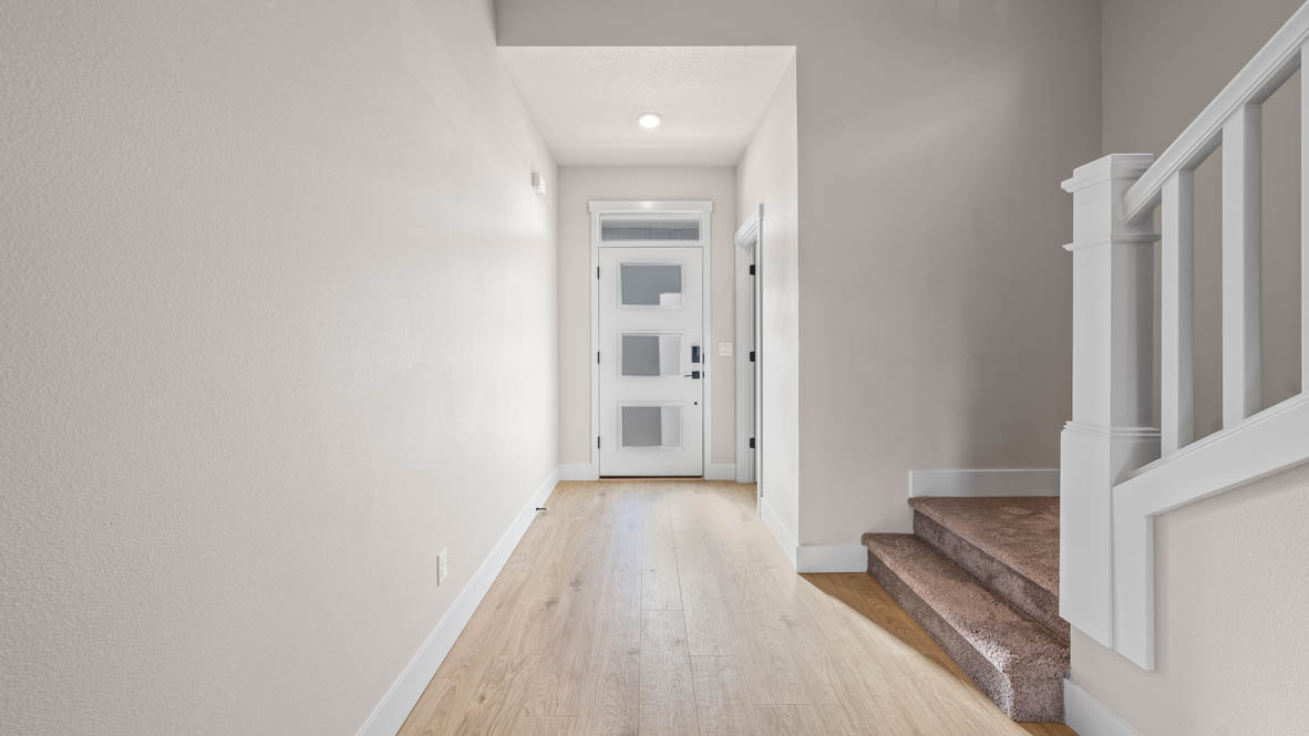 Stevens Ranch Entry with laminate flooring, staircase, and front door