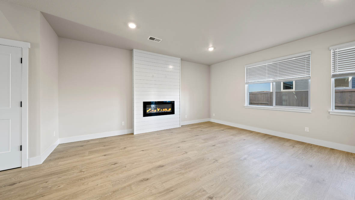 Stevens Ranch great room with windows, electric fireplace, windows, and flooring