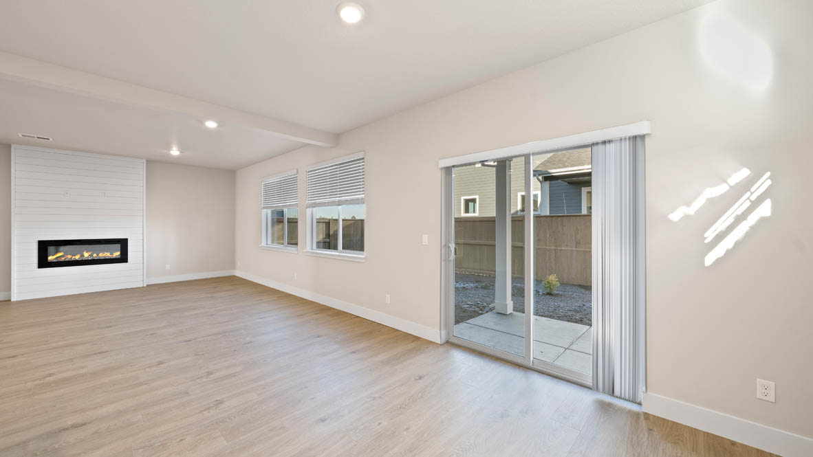 Stevens Ranch great room with windows, electric fireplace, windows, and flooring