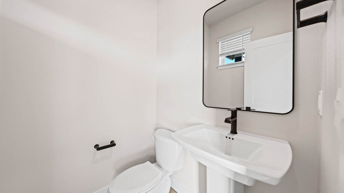 Stevens Ranch powder room with mirror, single sink vanity, and toilet