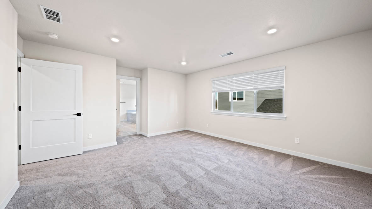 Stevens Ranch primary bedroom with carpet and windows