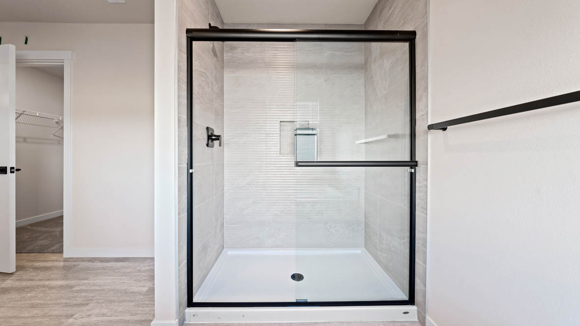 Stevens Ranch primary bathroom with walk in shower and sliding glass door