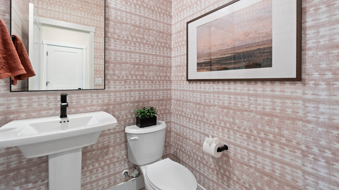 Stevens Ranch powder room with wallpaper, pedestal sink, and toilet