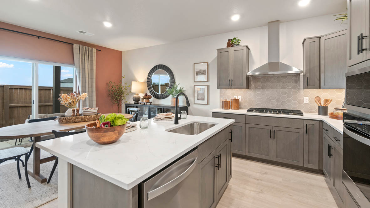Stevens Ranch Kitchen with island and white quartz countertops, stained wood shaker style cabinets, stainless steel appliances and full height geometric backsplash