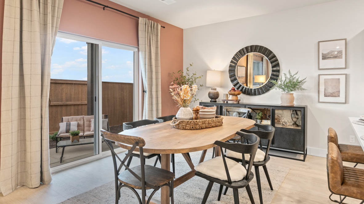 Stevens Ranch Dining Room with six-piece dining set, credenza with circular mirror above, and a sliding glass door to backyard