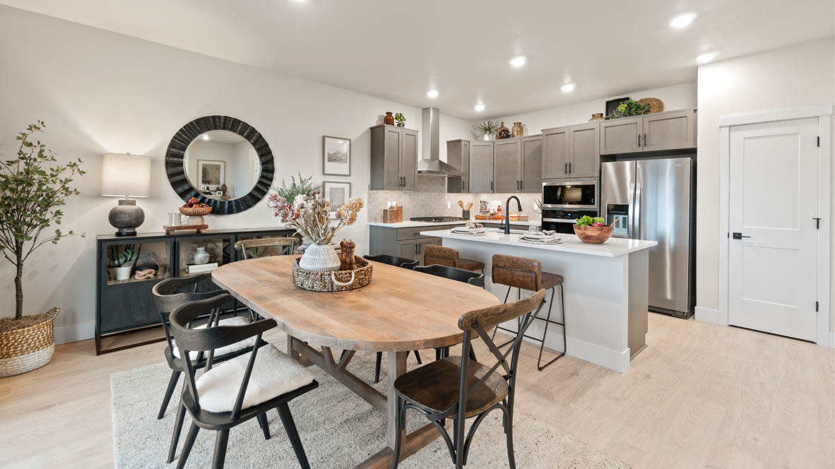 Stevens Ranch Dining Room with six-piece dining set, credenza with circular mirror above, and a sliding glass door to backyard