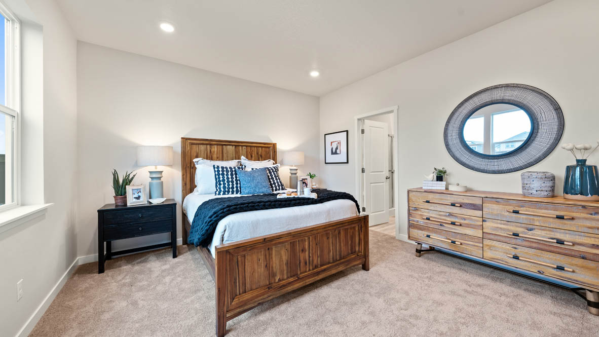 Stevens Ranch Primary Bedroom with carpet, bed, nightstand, mirror, dresser, and window