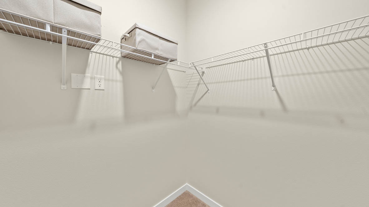 Stevens Ranch primary walk in closet with white wire shelving