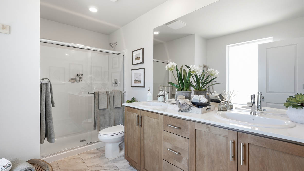 Stevens Ranch primary bathroom with double sink vanity and walk in closet