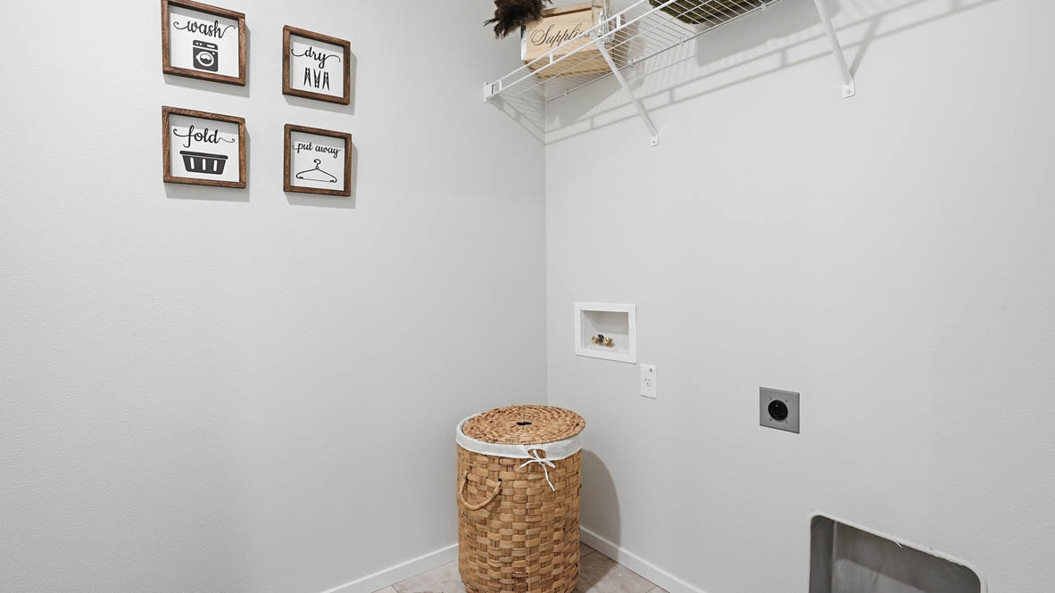 Stevens Ranch Townhomes laundry room with white wire shelving