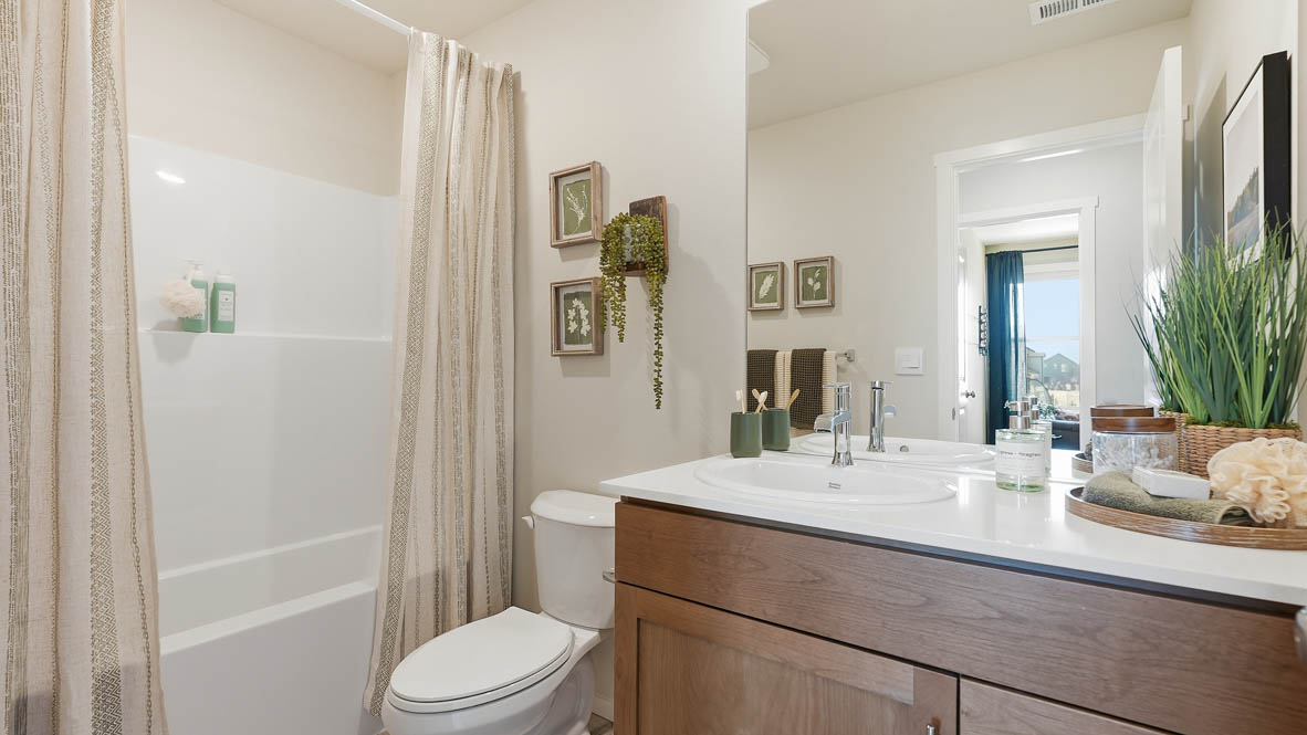 Stevens Ranch secondary bathroom with stained cabinets and a single sink vanity