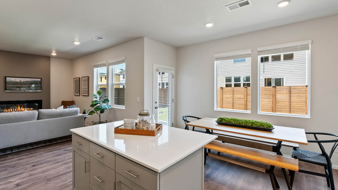 Monrovia dining and Kitchen with quartz island, stainless steel appliances, cabinets