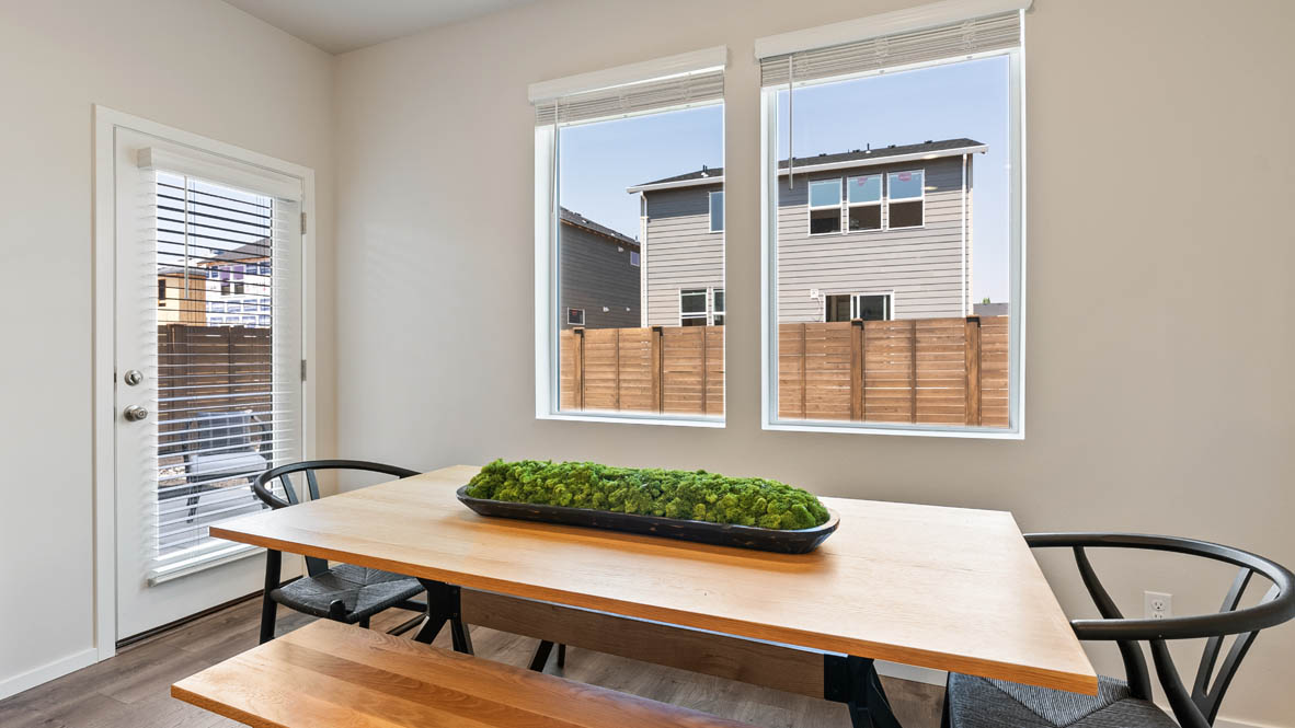 Monrovia Dining room with a table, chairs, white walls, and windows