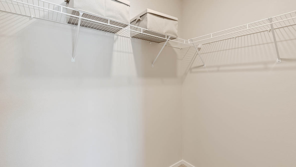 Monrovia walk in closet with white wire shelving