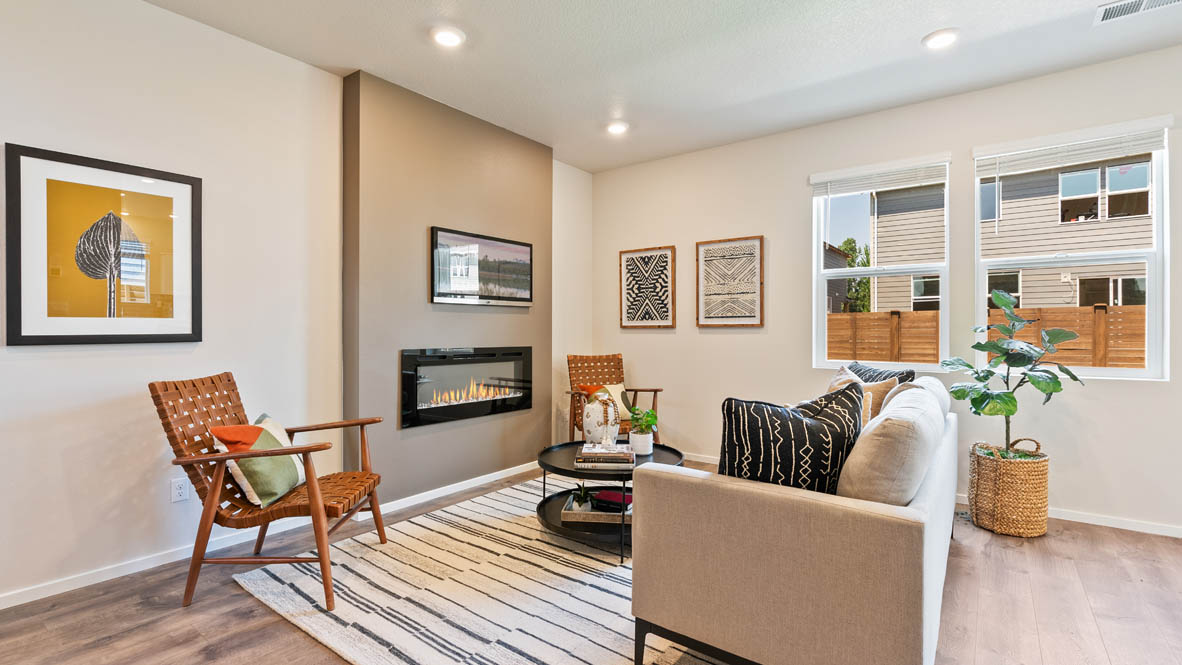 Monrovia great room with carpet, orange chair, walls, fireplace, window, and couch