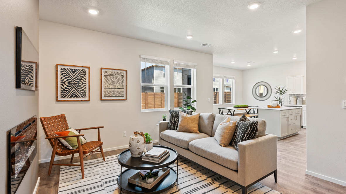 Monrovia great room with carpet, orange chair, walls, fireplace, window, and couch