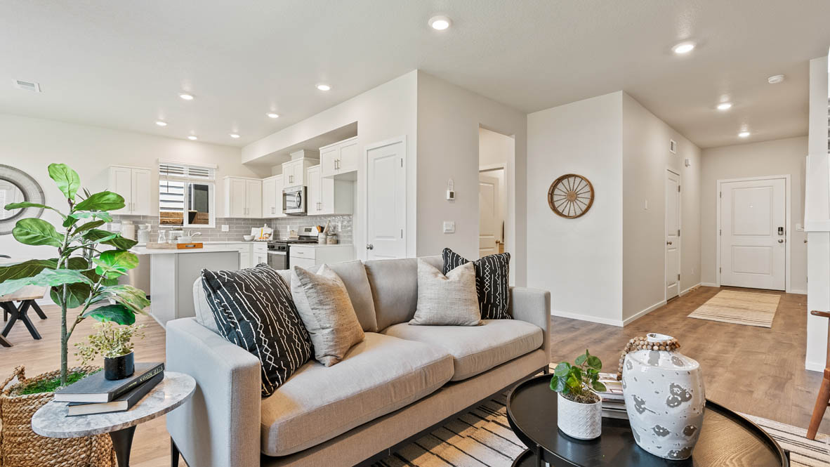 Monrovia great room with carpet, orange chair, walls, fireplace, coffee table, and couch