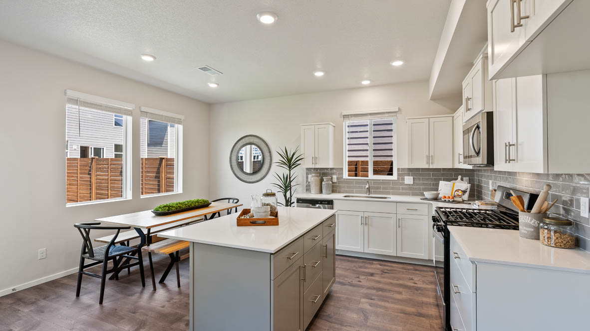 Monrovia dining and Kitchen with quartz island, stainless steel appliances, cabinets